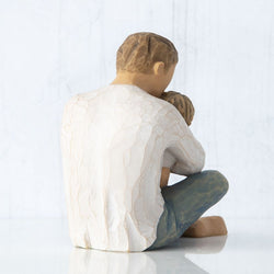 Willow Tree Little One 
seated father holding child in arms 
Back view 